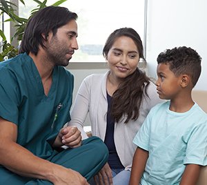 Healthcare provider talking to woman and boy.